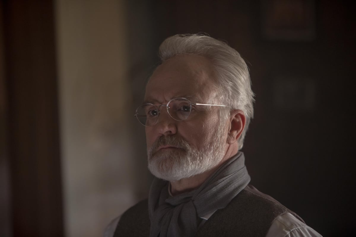 Commander Lawrence from The Handmaid's Tale with a white beard and glasses. 