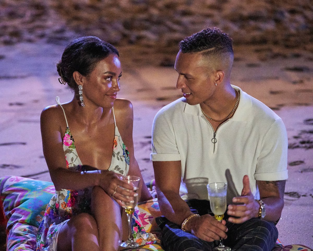 On Bachelor in Paradise Season 8, Serena and Brandon talk while sitting on pillows on the sand. 