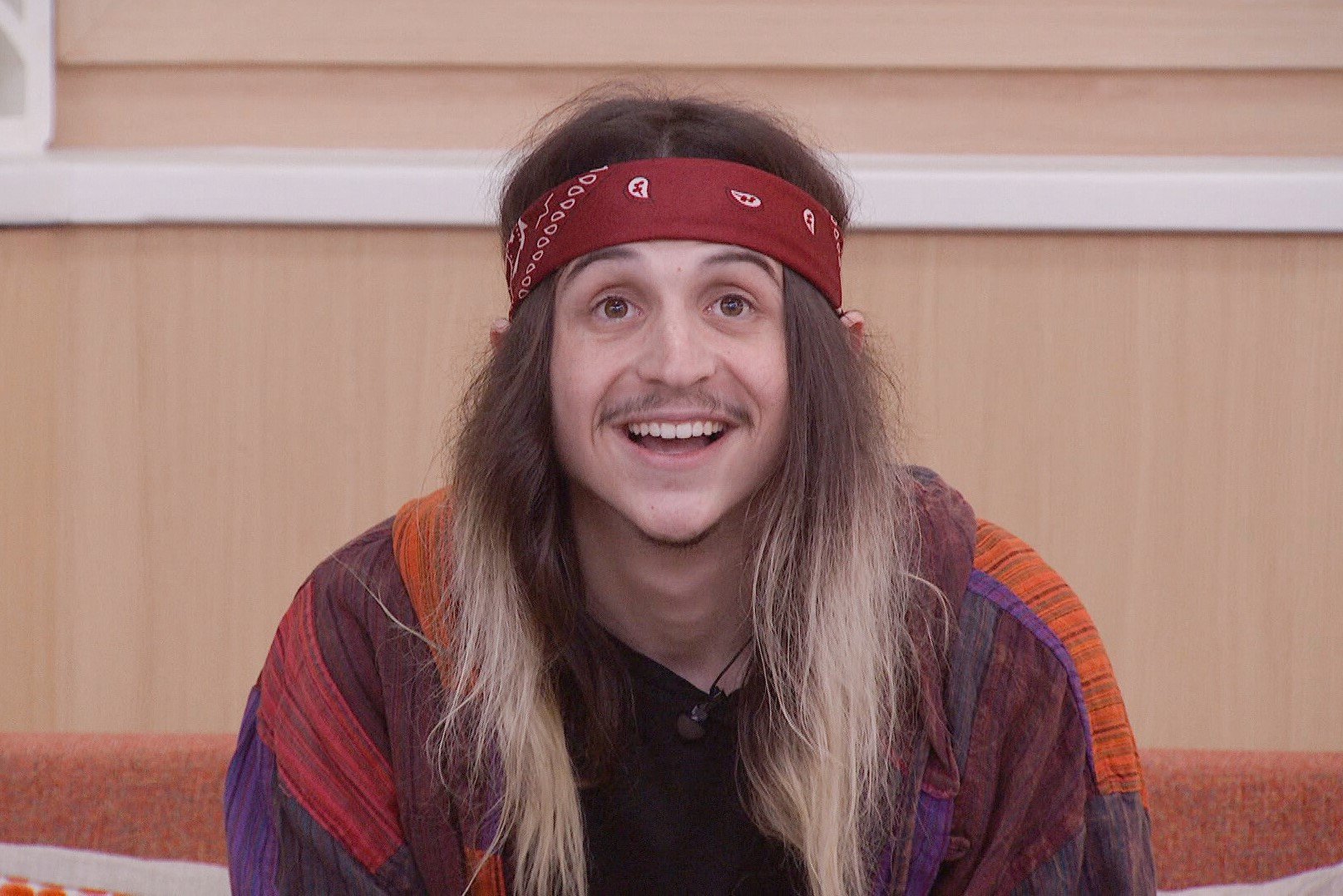 Matthew Turner, who came in third place in 'Big Brother 24' on CBS, wears a multi-colored jacket over a black shirt and a dark red bandana around his head.