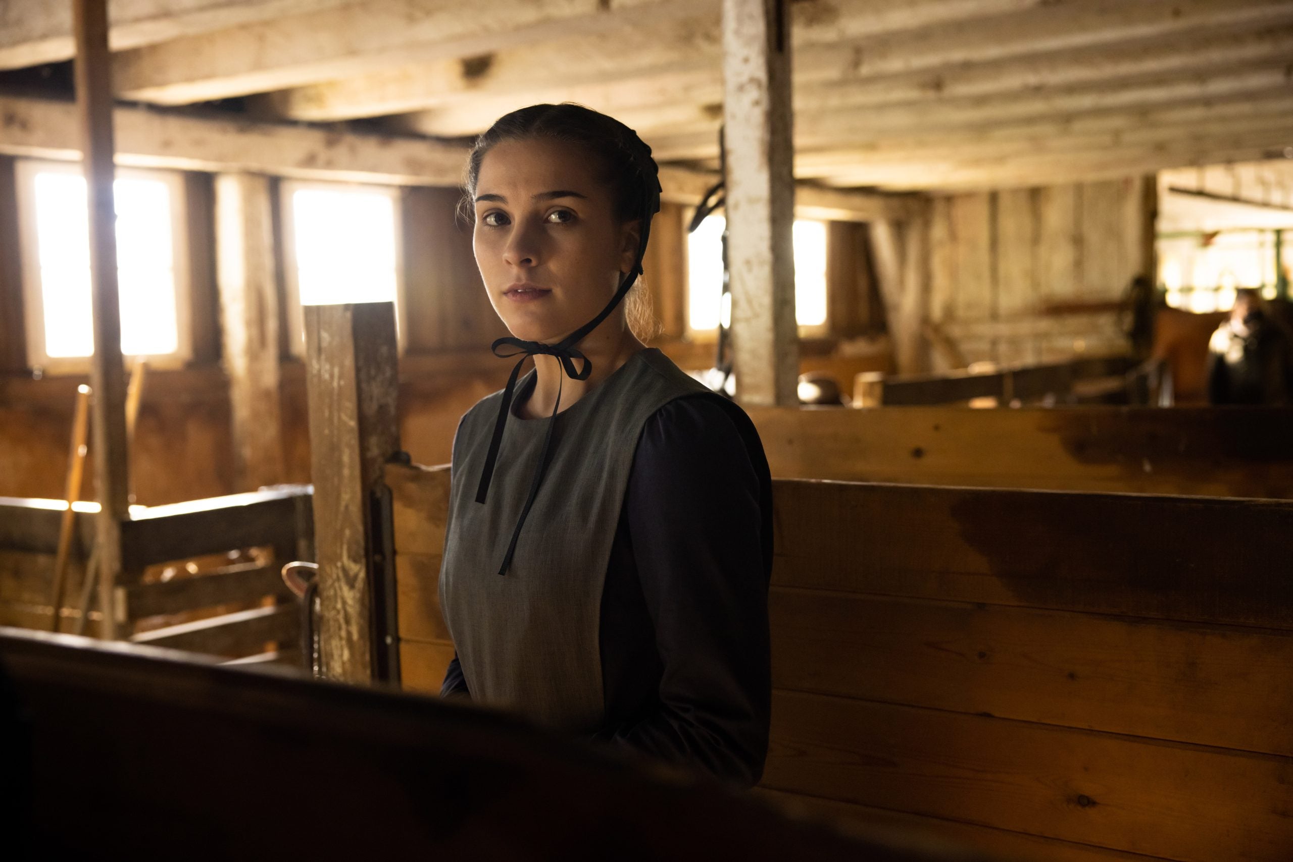 A young woman dressed in Amish clothing in the Lifetime movie 'An Amish Sin'