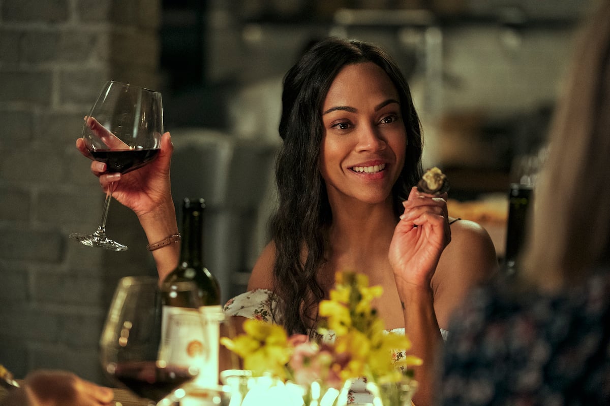 Zoe Saldana holding a glass of win in 'From Scratch' on Netflix