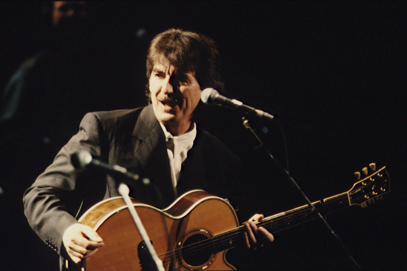 George Harrison performing in black in 1992.