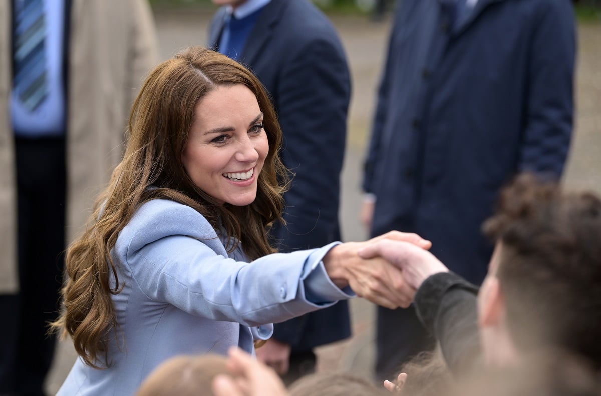 Kate Middleton, who dealt with a heckler who a body language expert said tried to make her "feel helpless," greeting the public during her visit to Carrickfergus Castle in Northern Ireland