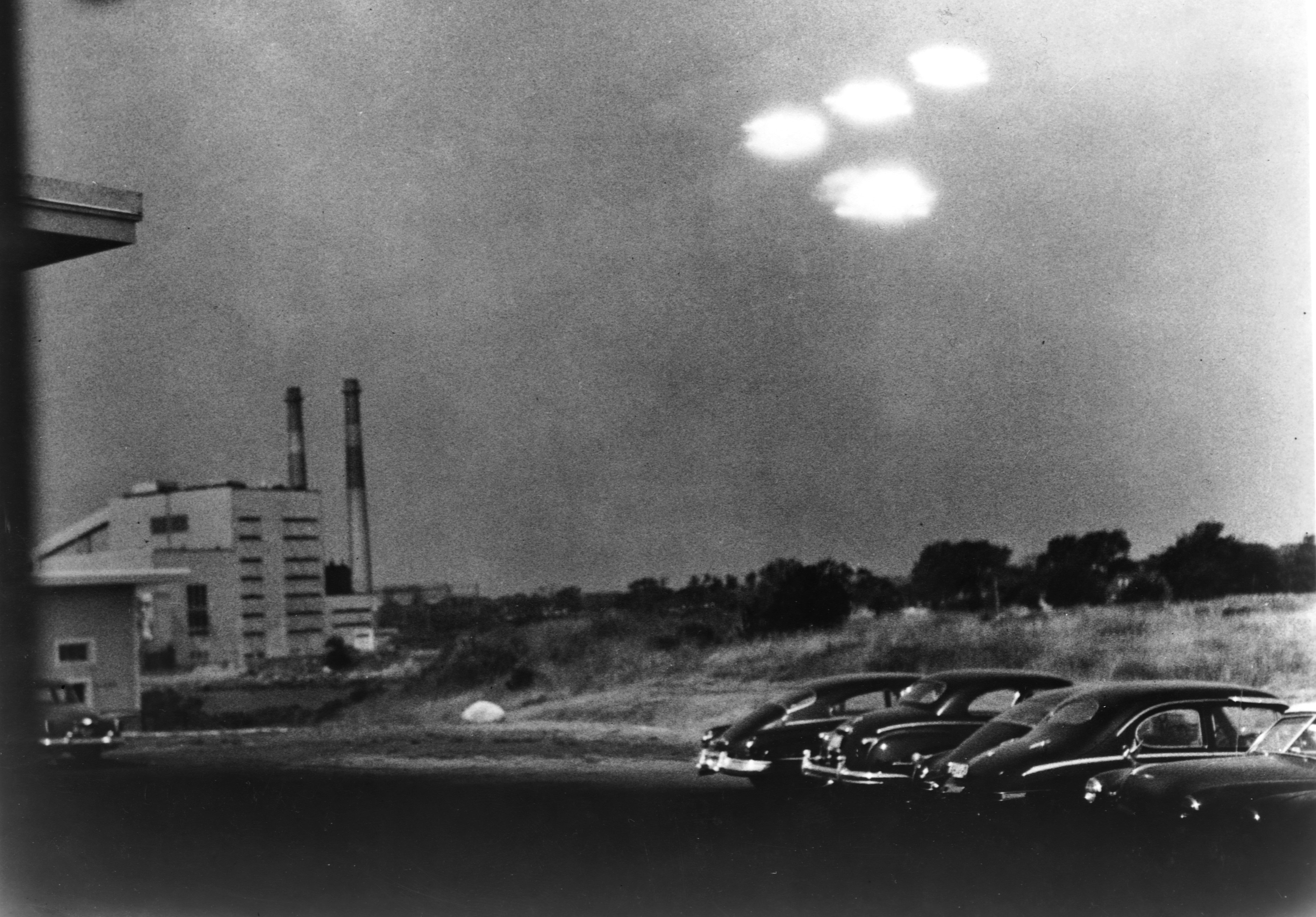 Flying saucers above cars