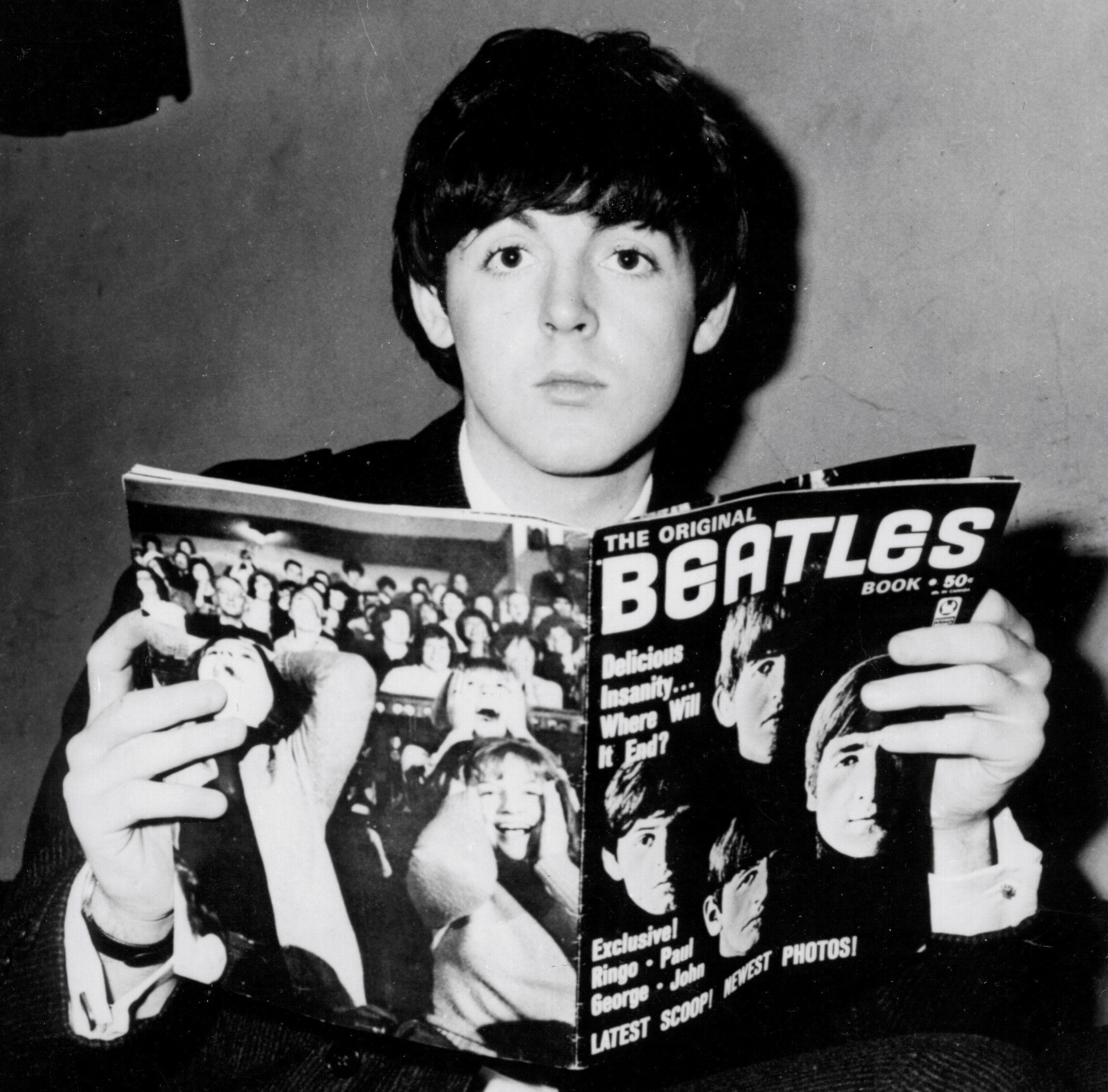 The Beatles' Paul McCartney with a magazine