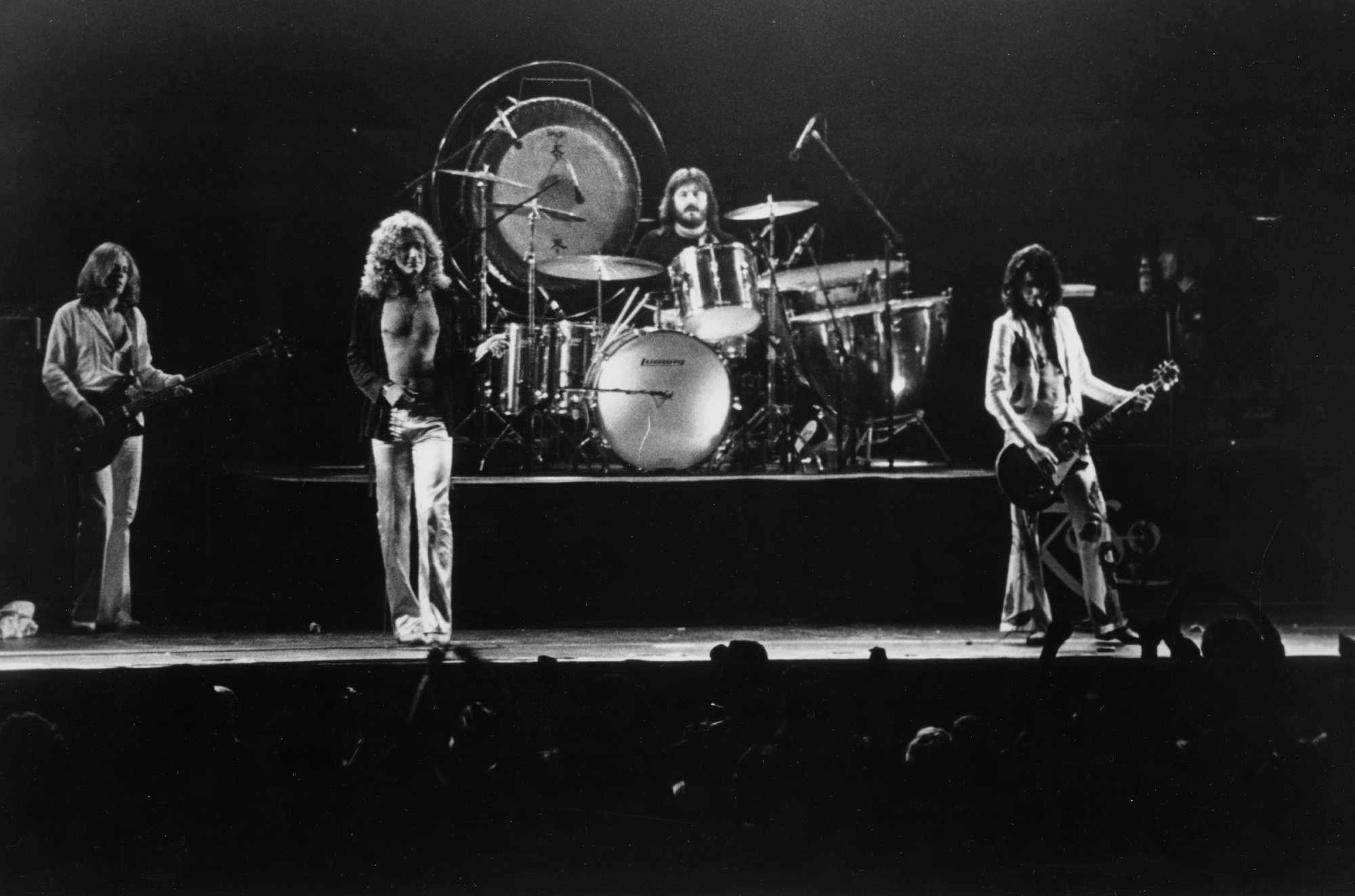 A black-and-white photo of Led Zeppelin performing onstage in 1977