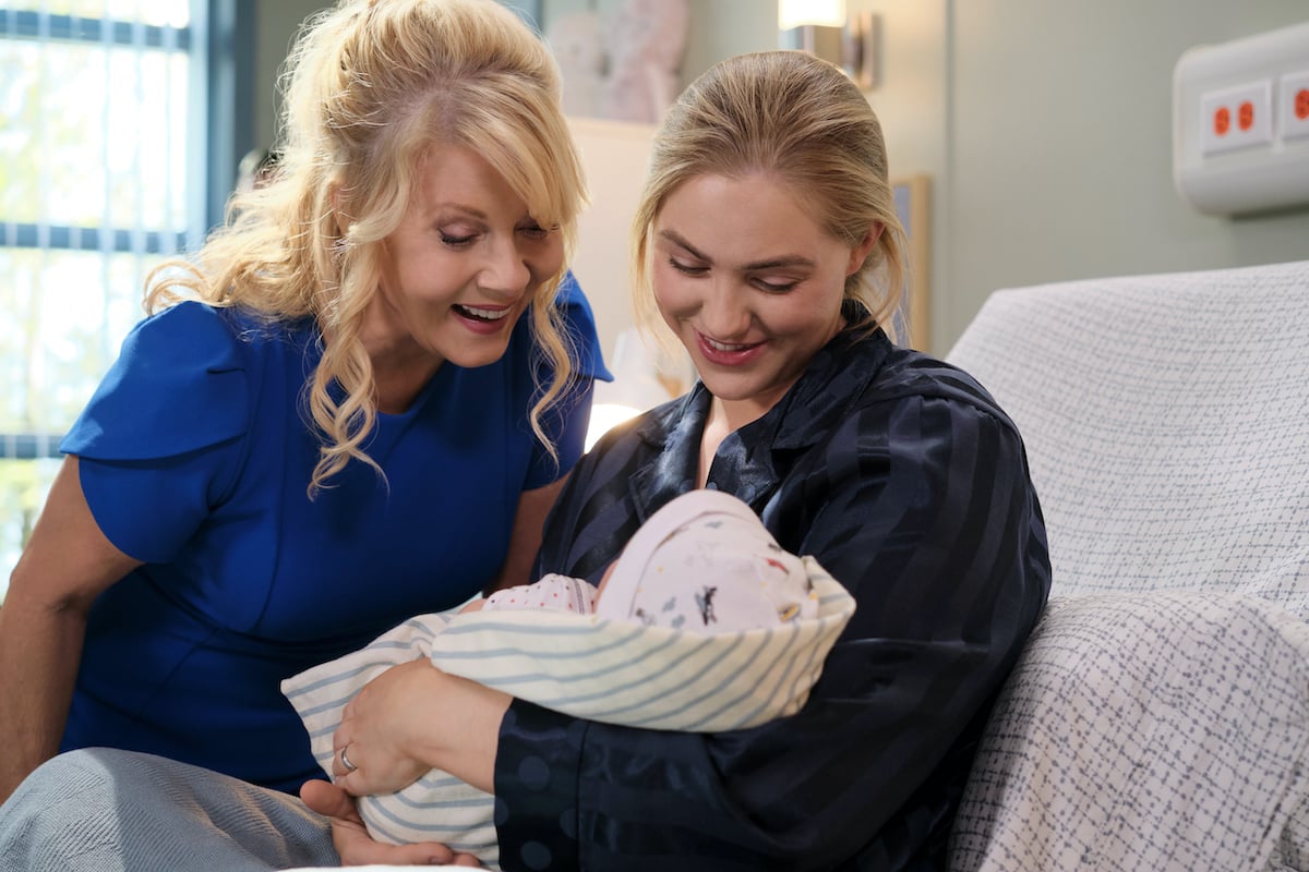 Sarah holding her new baby as Megan looks on in the 'Chesapeake Shores' series finale