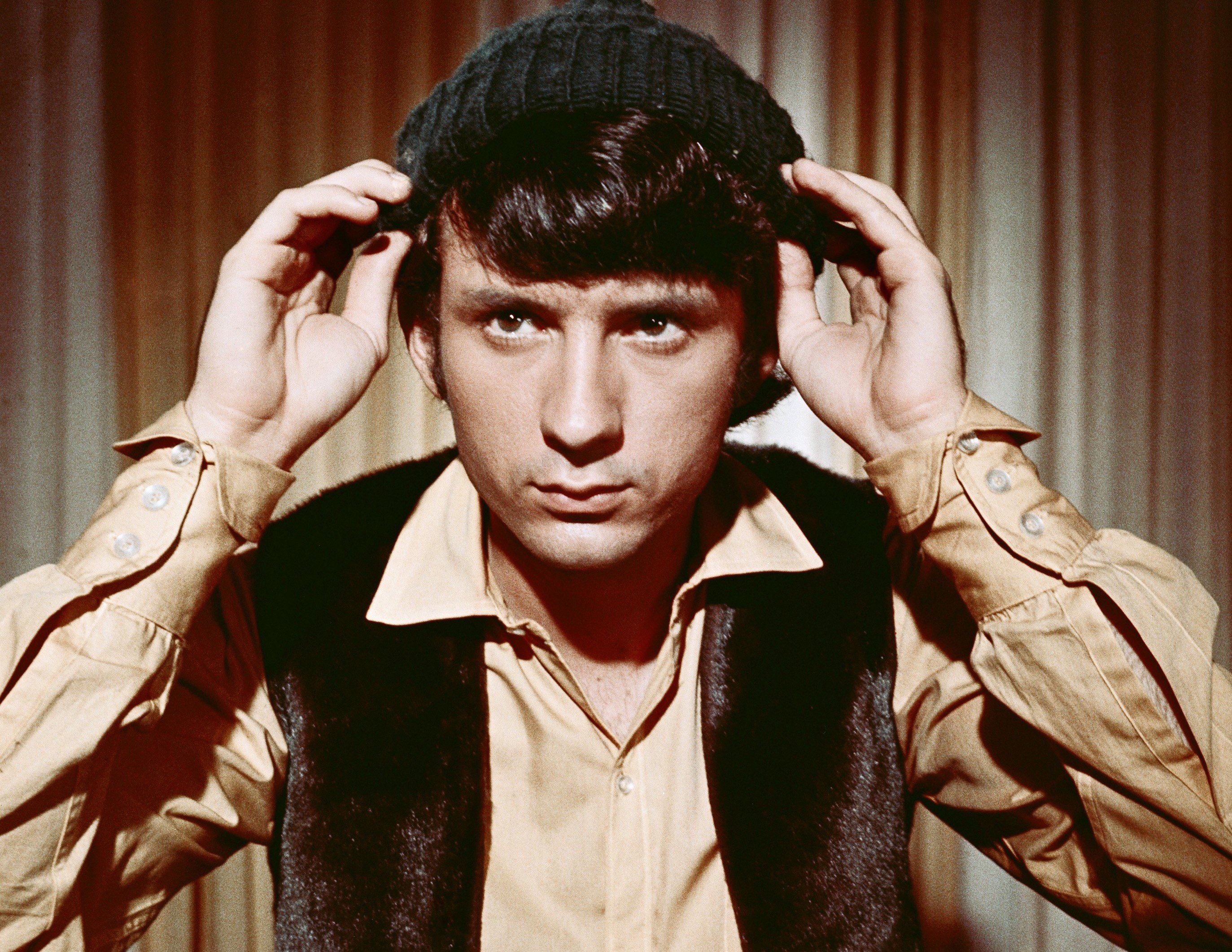 The Monkees' Mike Nesmith in front of a curtain