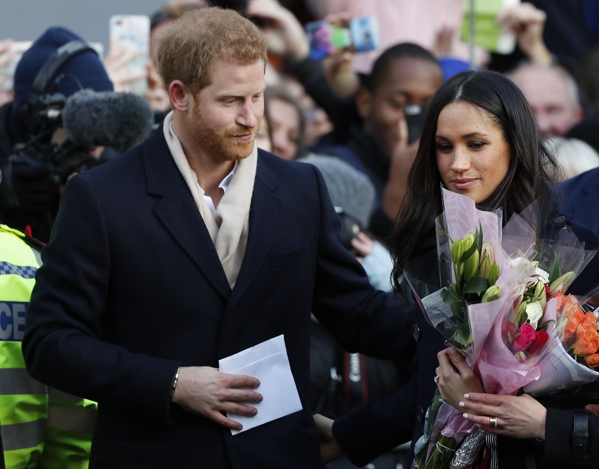 Prince Harry and Meghan Markle, who Harry's biographer accused of not "behaving with compassion," greeted by well-wishers during visit to Nottingham Contemporary