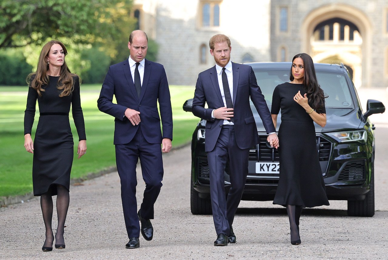 (L-R) Kate Middleton, Prince William, Prince Harry, and Meghan Markle at Windsor Castle on September 10, 2022, in Windsor, England. Some observers wondered if Harry was holding Meghan back at one point that day.