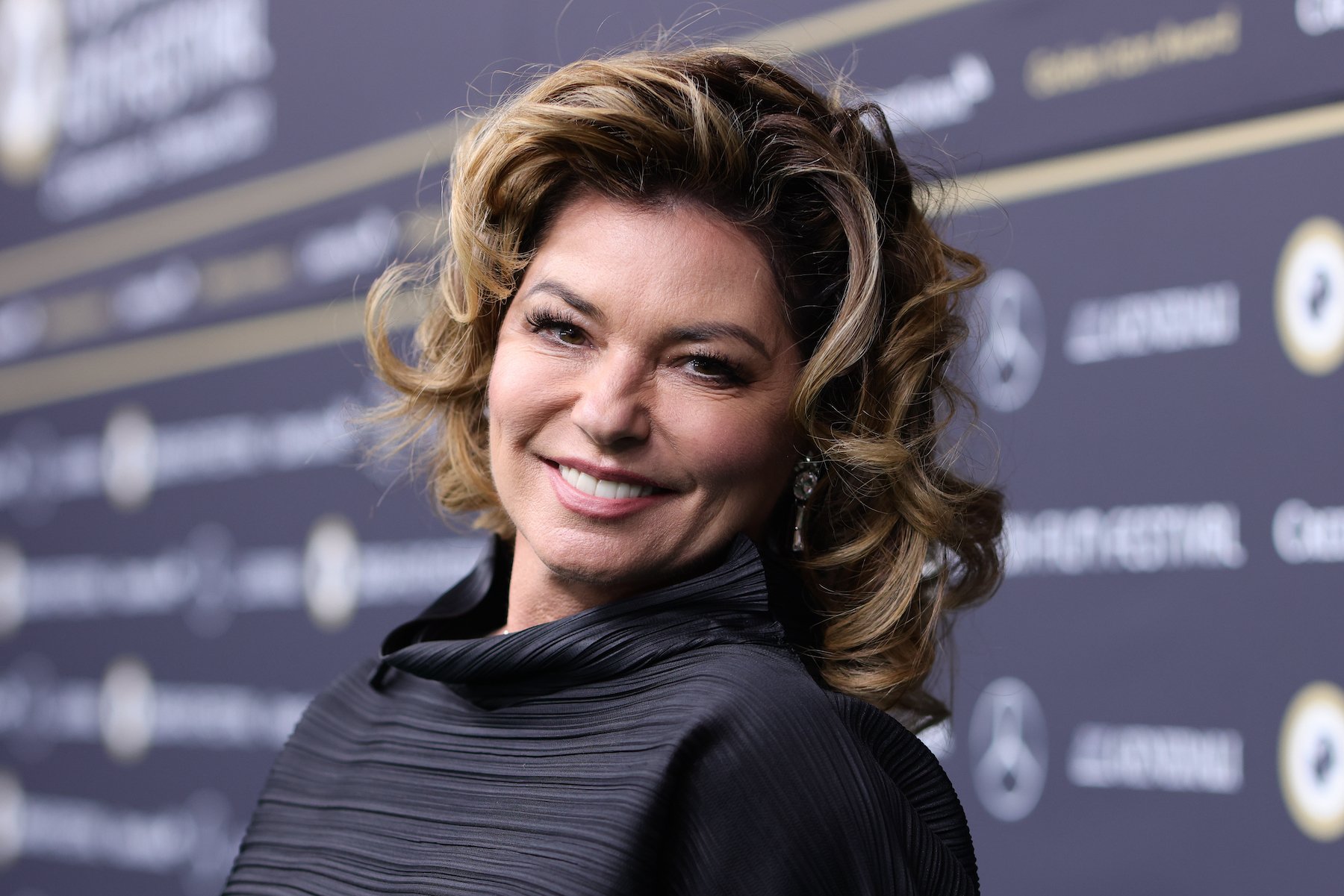 Shania Twain, who looks up to certain artists with soul, wearing a black sweater