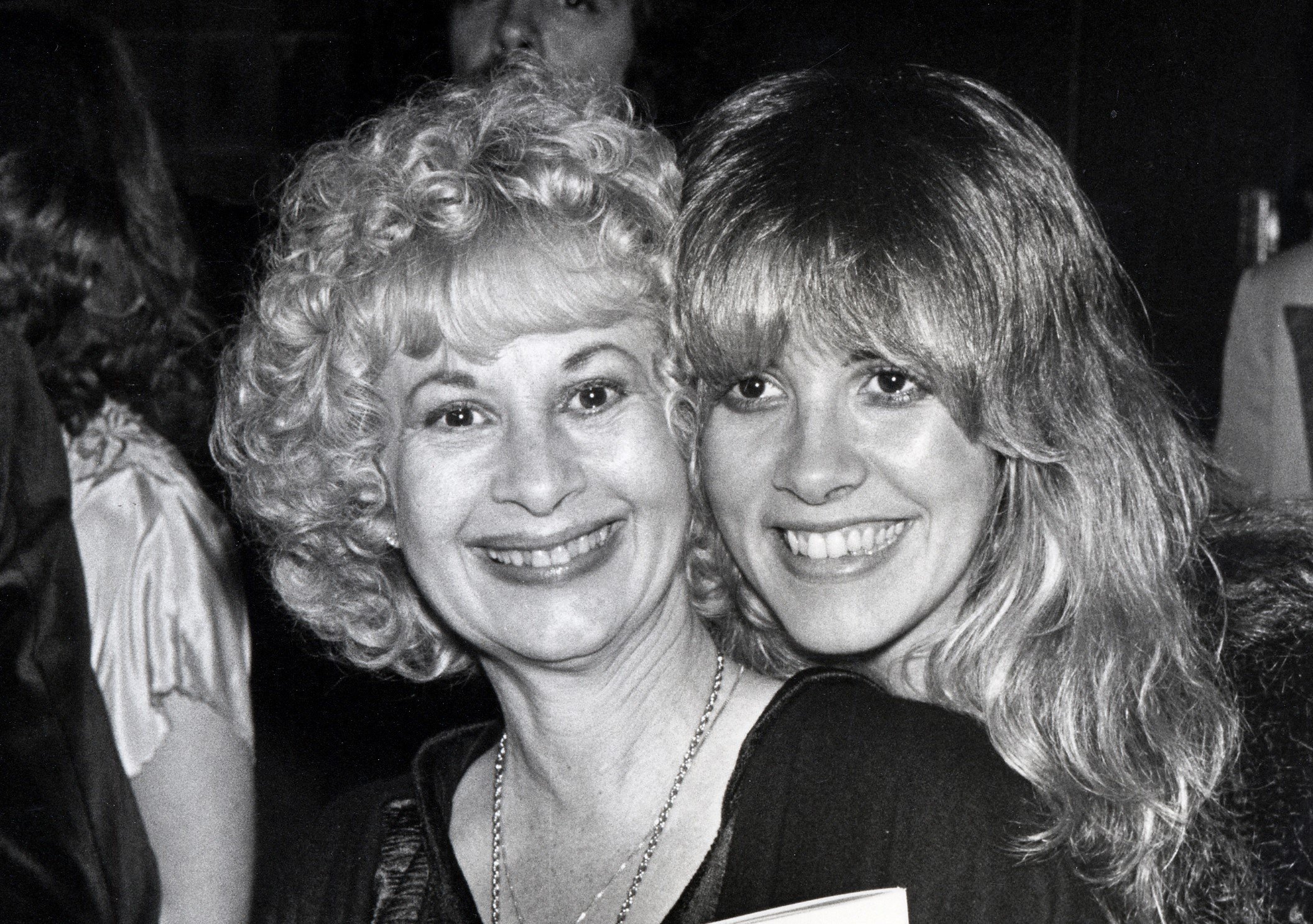 A black and white picture of Stevie Nicks standing behind her mother, Barbara Nicks. 