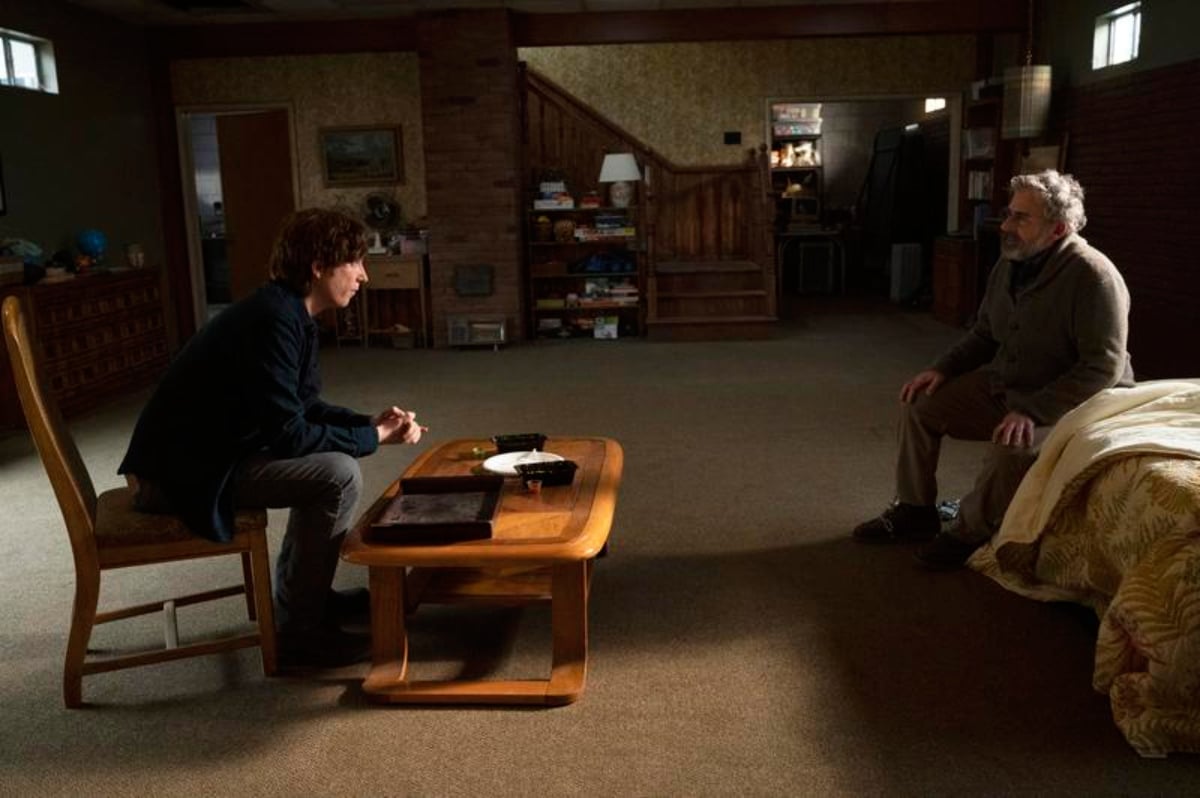 Food plays an important role in The Patient. Sam and Alan sit on either side of a table in Sam's basement. 