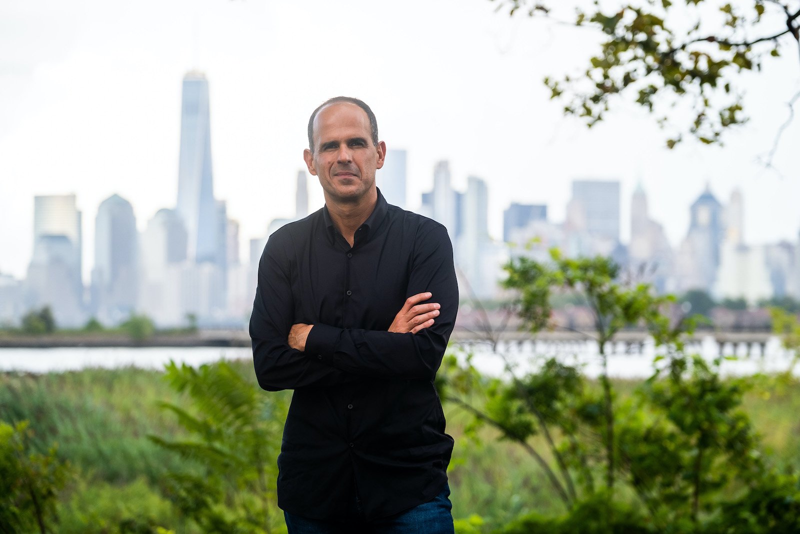 Marcus Lemonis from 'The Renovator' stands with his arms folded 
