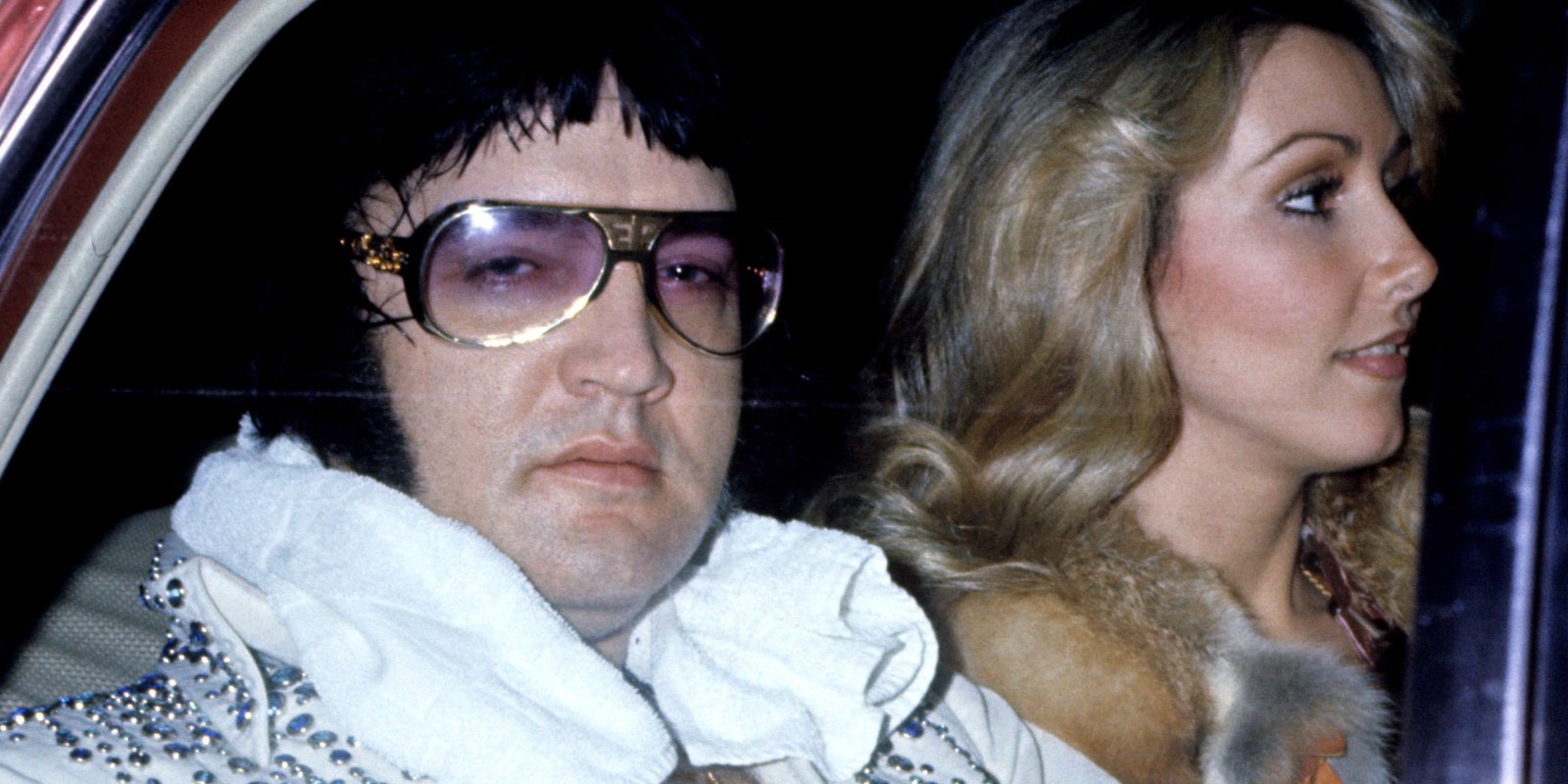 Elvis Presley and Linda Thompson are photographed in a car in 1976.