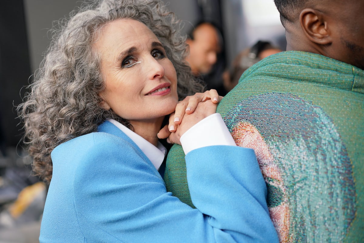 Smiling Andie MacDowell wearing a blue jacket