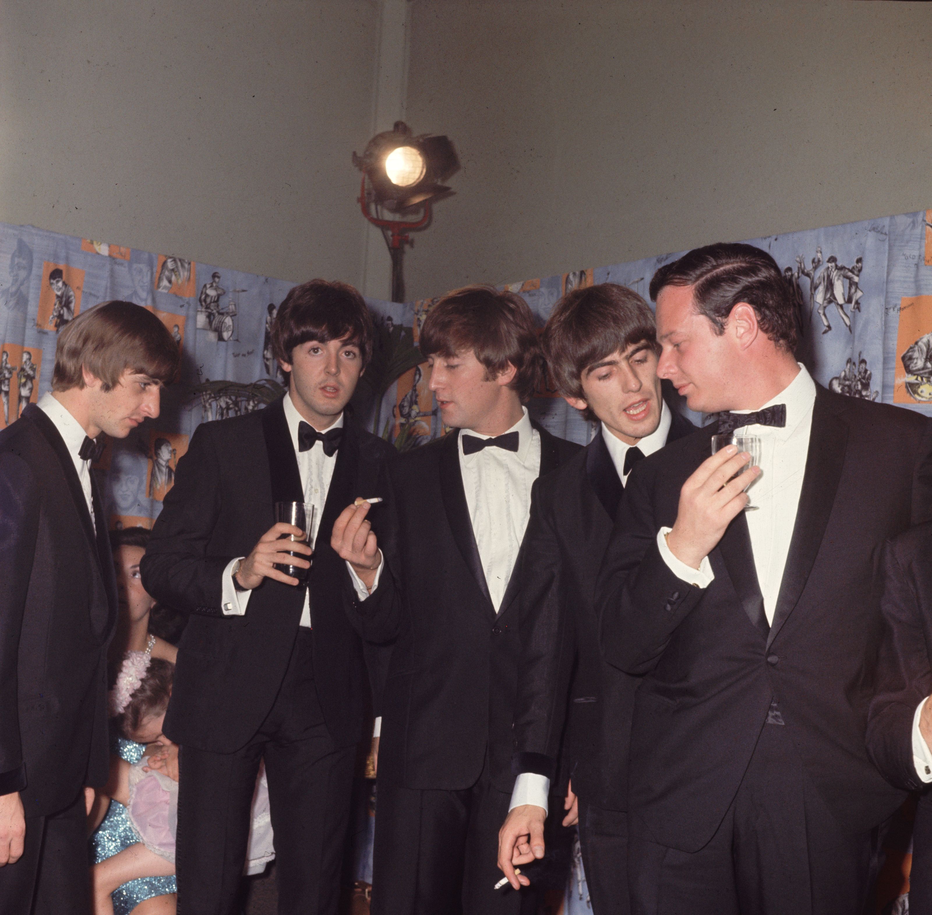 George Harrison (1943 - 2001), John Lennon (1940 - 1980), Paul McCartney, and Ringo Starr of The Beatles with their manager Brian Epstein (1935 - 1967)