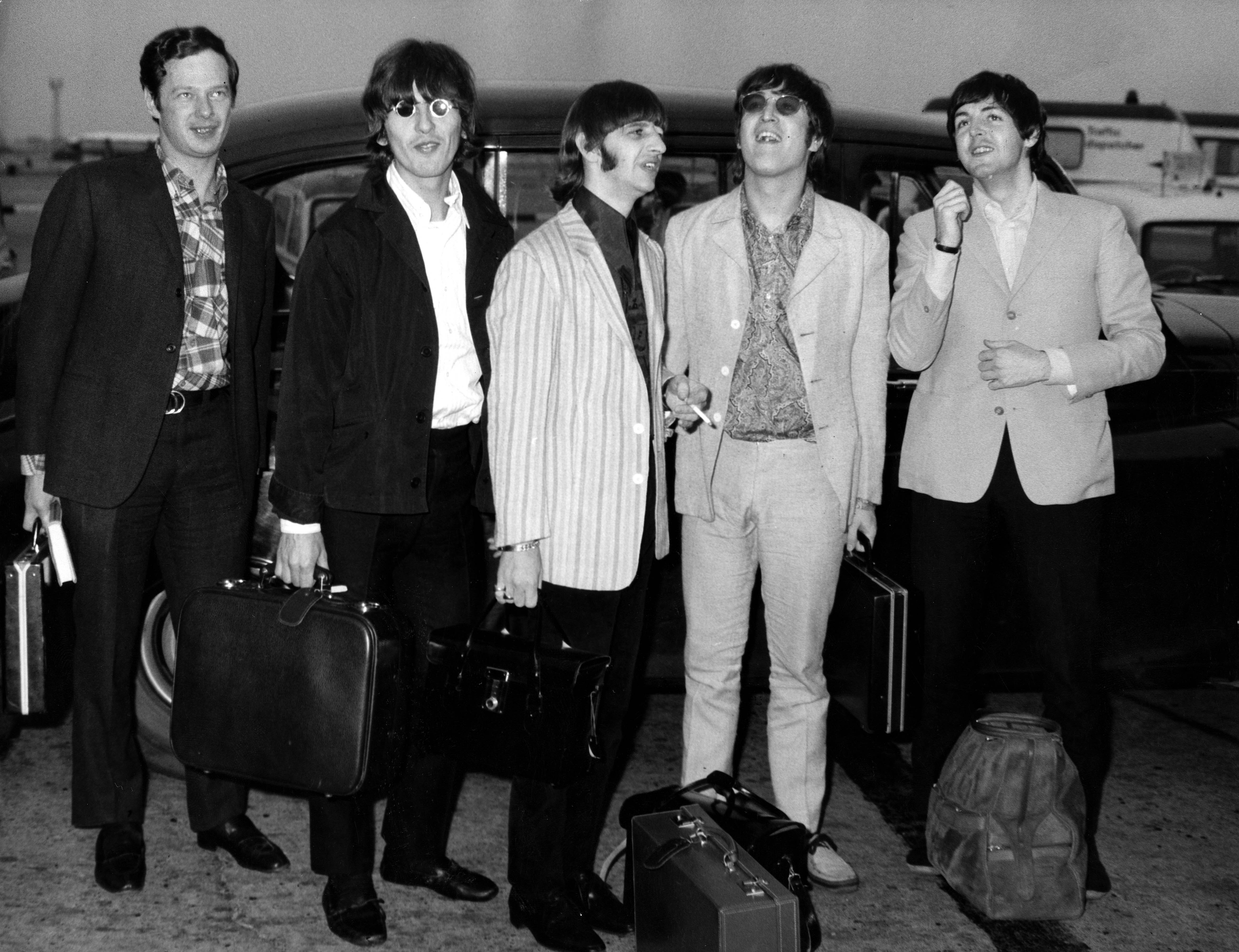 Photo of The Beatles and Brian Epstein (Brian Epstein, George Harrison, Ringo Starr, John Lennon, Paul McCartney) arriving back at Heathrow