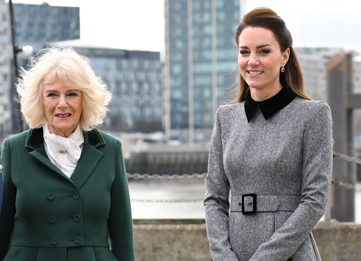 Camilla Parker Bowles and Kate Middleton, who a body language expert said had a concerning gesture around her stepmother-in-law, arrive for their visit to The Prince's Foundation training site for arts and culture