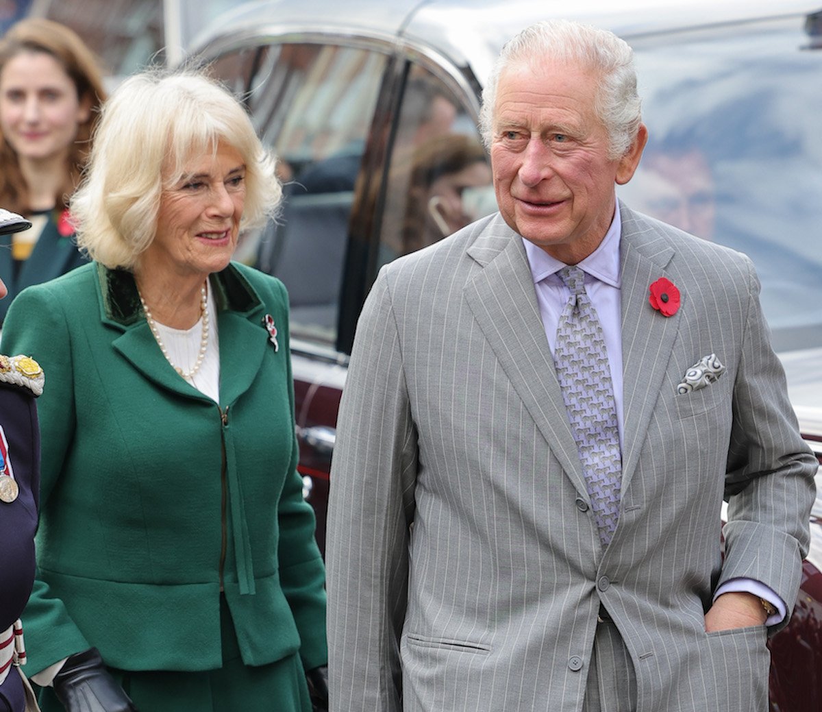 Camilla Parker Bowles and King Charles, who reacted differently to a protestor throwing eggs at them in York, England, according to a body language expert, walk together on Nov. 9, 2022