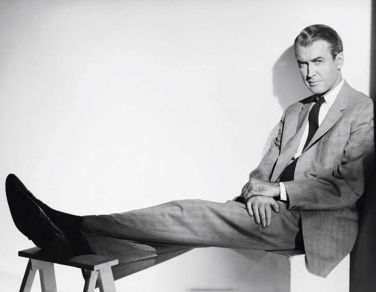 Jimmy Stewart, seated, in black and white