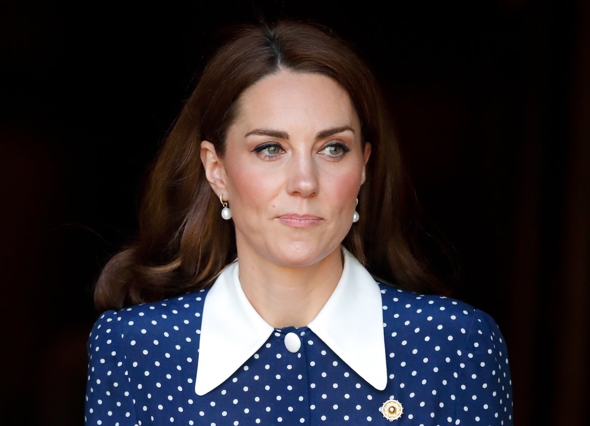 Kate Middleton, who appeared 'direct and assertive' in an Addiction Awareness Week video, according to a body language expert, looks on wearing a blue and white polka dot dress