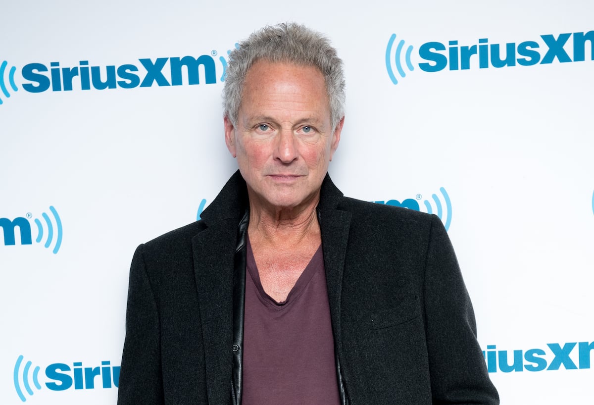 Lindsey Buckingham, who was accused of abuse by his ex-girlfriends, poses for the camera at an event.