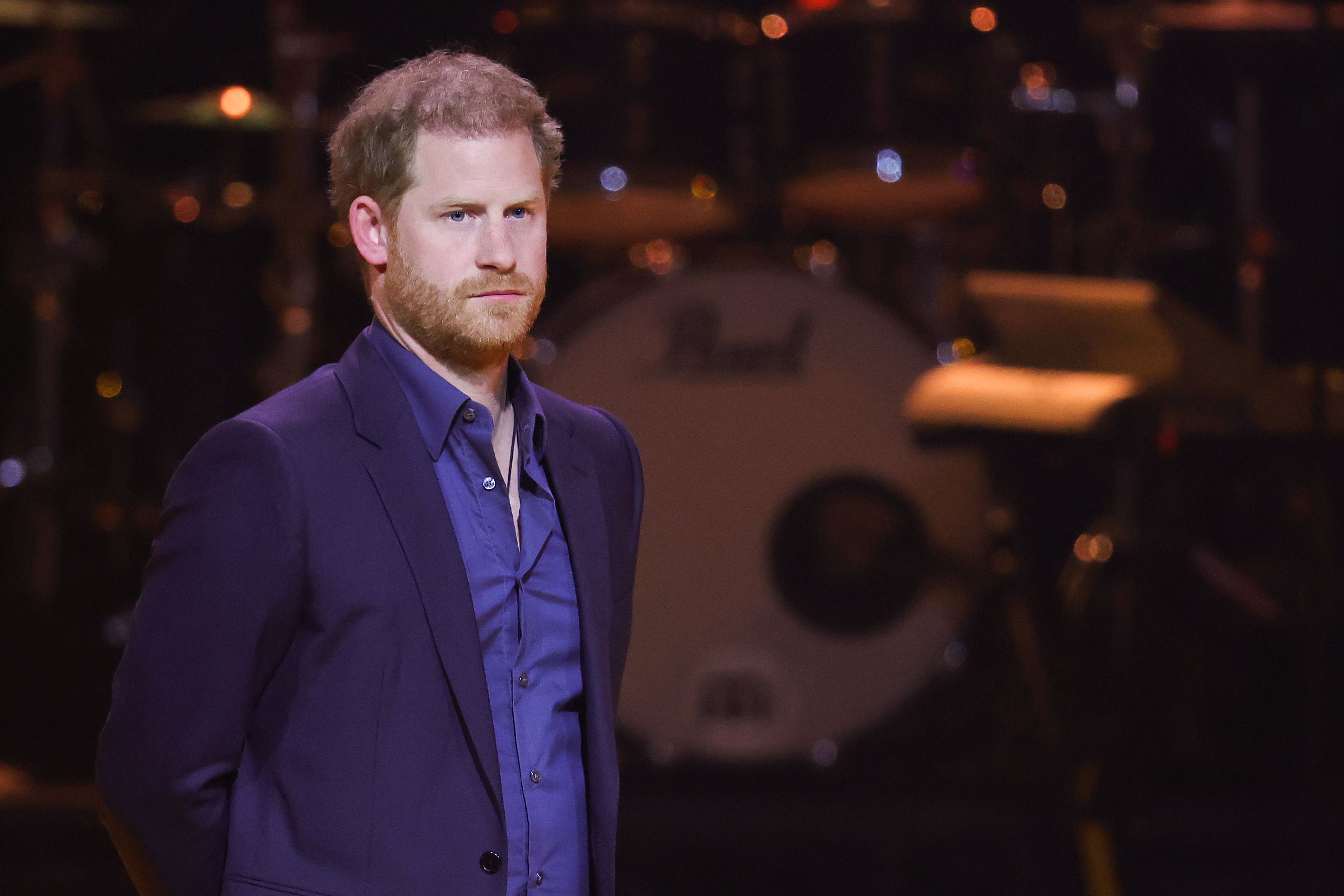 Prince Harry, who is reportedly "digging up painful childhood memories," on stage during the Invictus Games The Hague Closing Ceremony