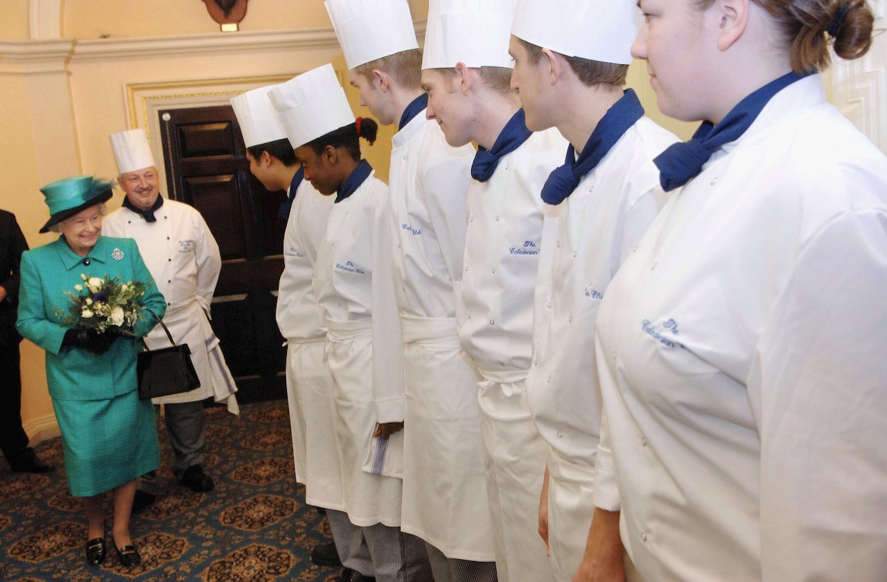 Queen Elizabeth ll meets kitchen staff during a St. Andrew's Day visit to the Caledonian Club in London, England, in 2006.