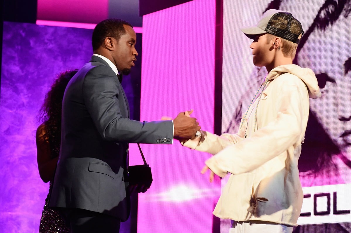 Sean P Diddy Combs and Justin Bieber handshake during the American Music Awards