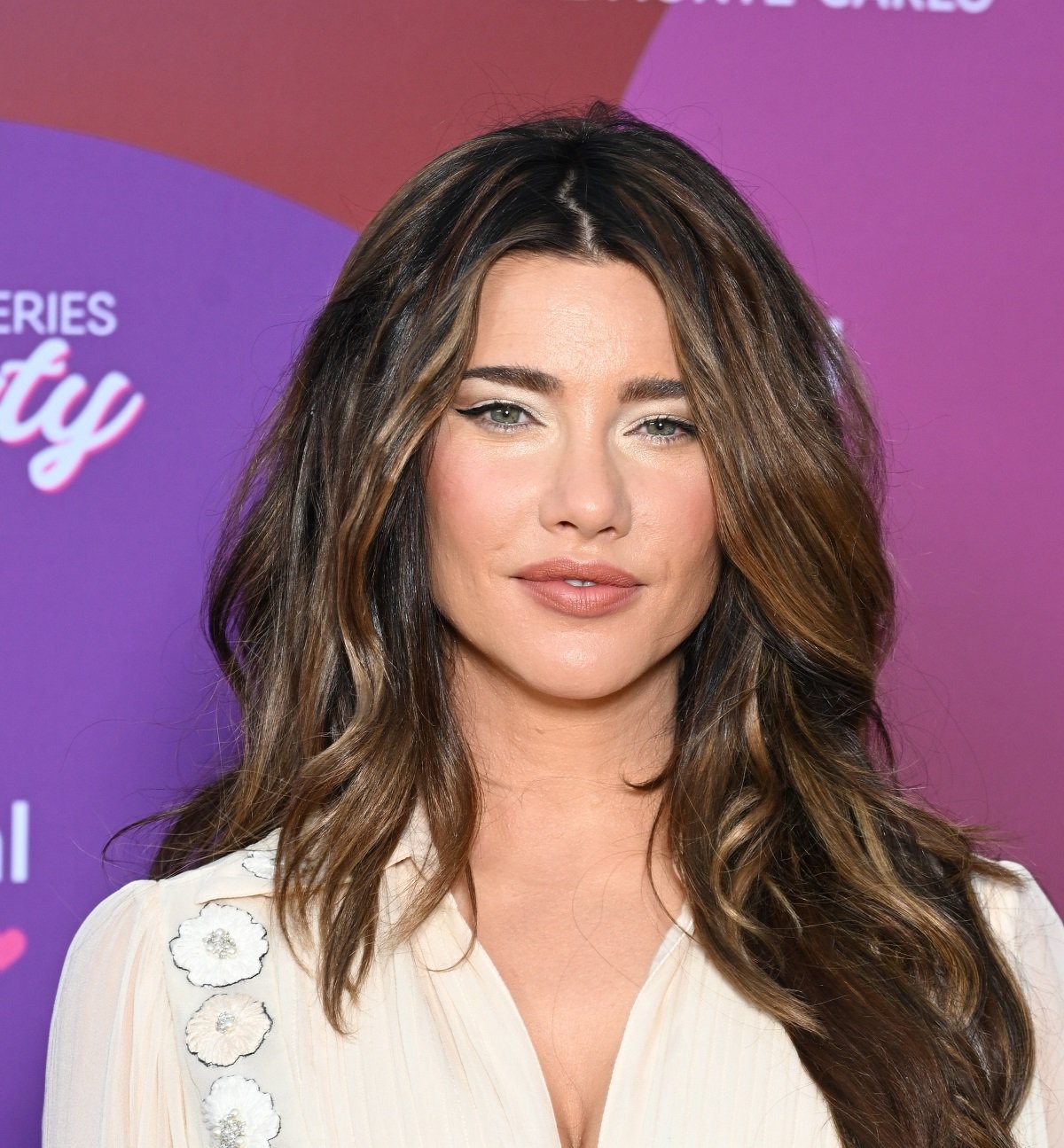 'The Bold and the Beautiful' star Jacqueline MacInnes Wood wearing a white dress, smiles for the camera.