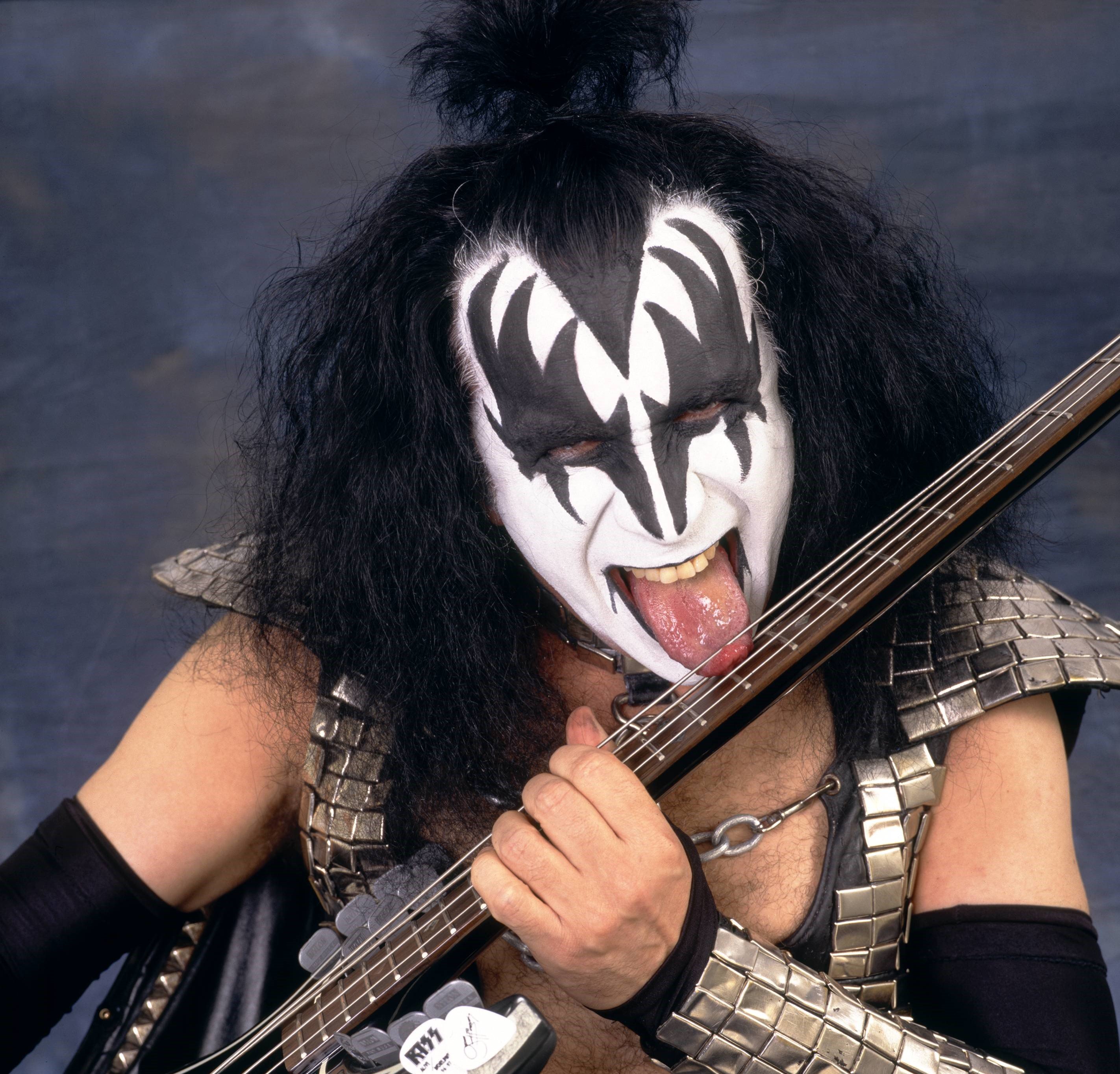 Kiss' Gene Simmons licking a guitar