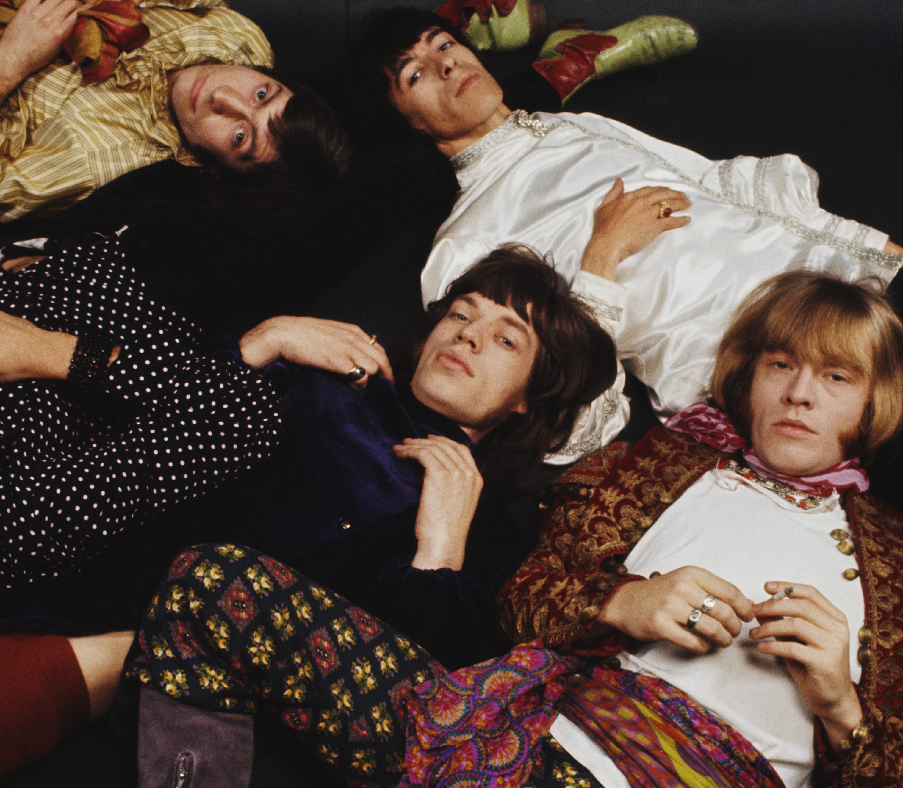 The Rolling Stones lying on a floor