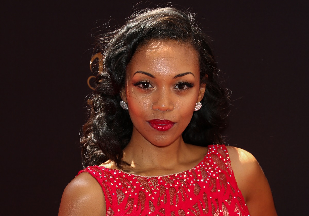 'The Young and the Restless' star Mishael Morgan wearing a red dress and posing for a photo.