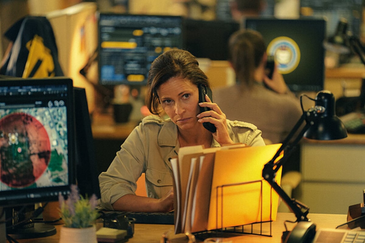 In Tulsa King Episode 2, ATF Agent Stacy Beale sits at her desk with a phone to her ear.