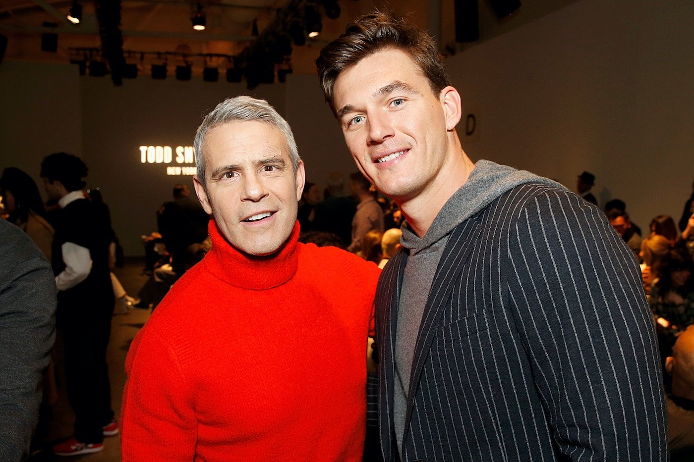 Andy Cohen and Tyler Cameron at an event 