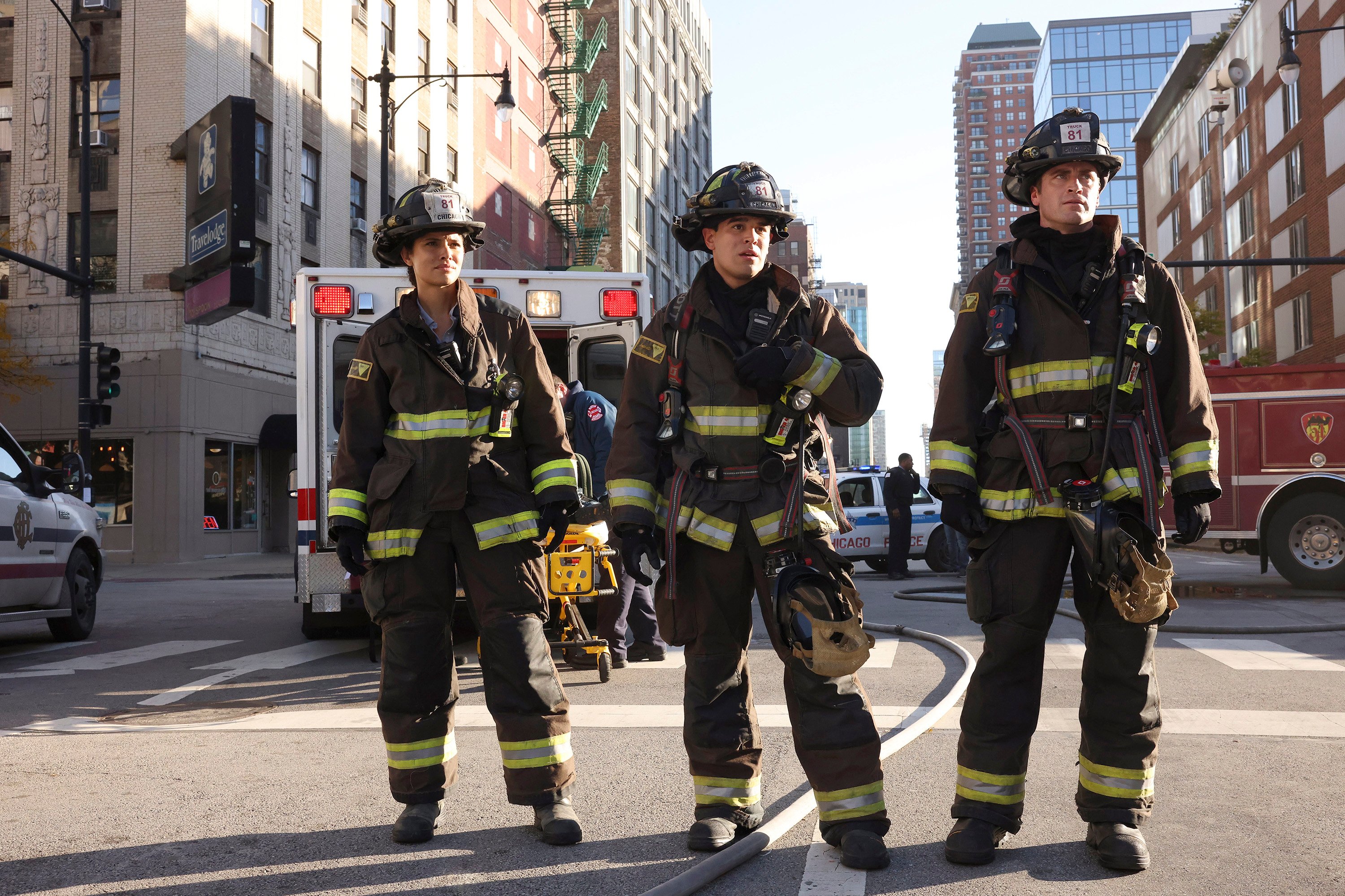 The cast of Chicago Fire stands together during an episode. 