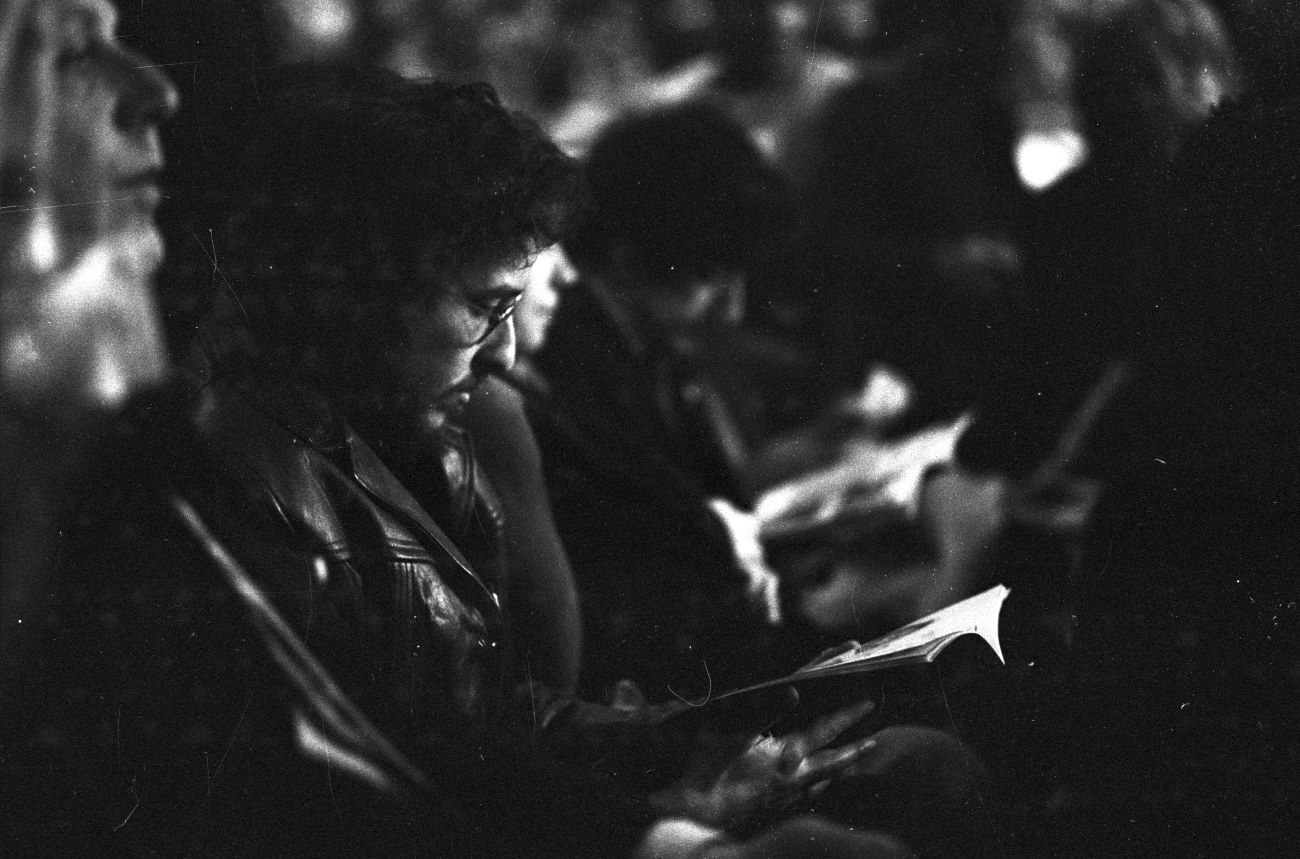 A black and white photo of Bob Dylan in the audience of the first  first Muhammad Ali-Joe Frazier title fighta