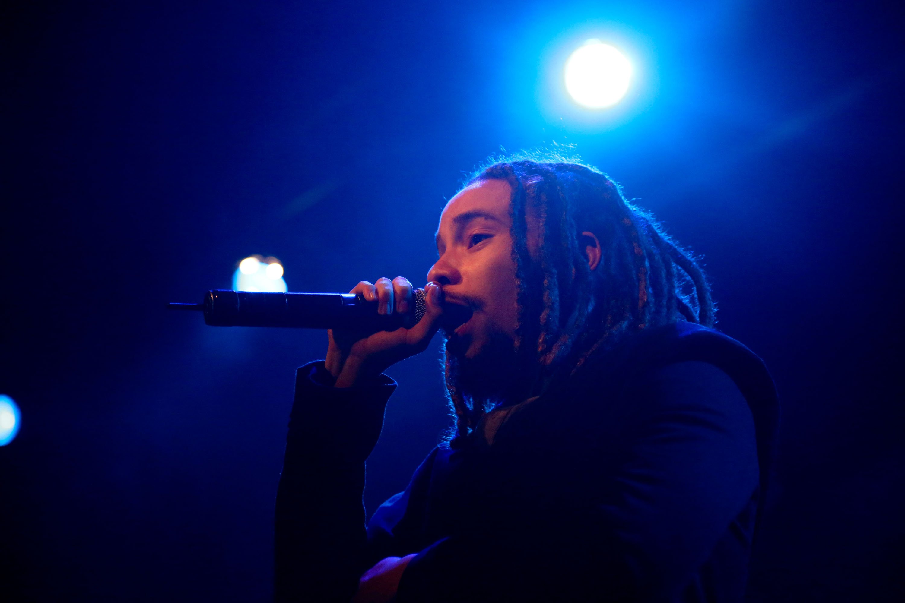 Bob Marley's grandson Jo Mersa Marley holds up a microphone