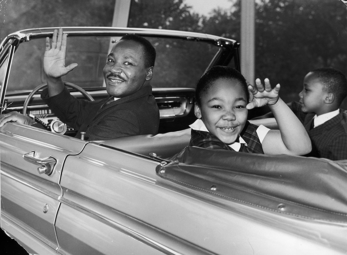 Martin Luther King Jr. waves to the camera with his children from a ride at the World's Fair.