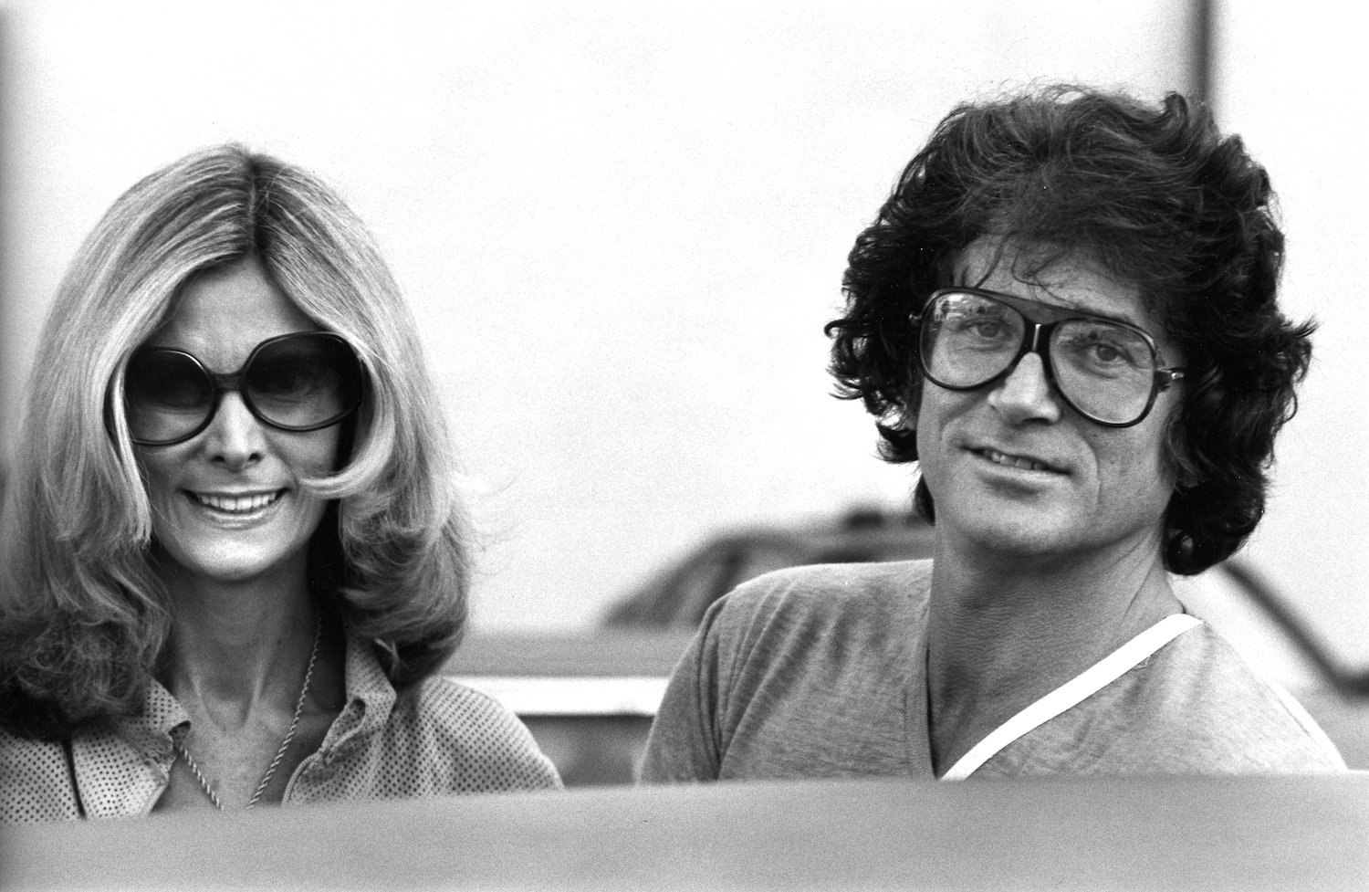 A black and white photo of 'Bonanza' star Michael Landon and wife Lynn Noe in a convertible