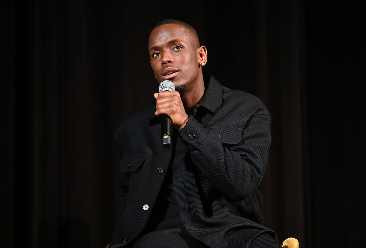 Micheal Ward speaks into a microphone at an event.