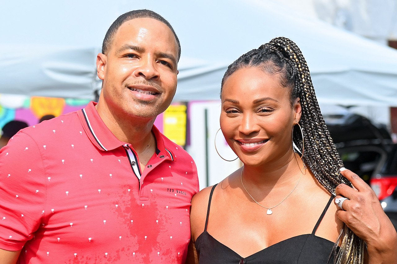 Mike Hill and Cynthia Bailey smile together for photo