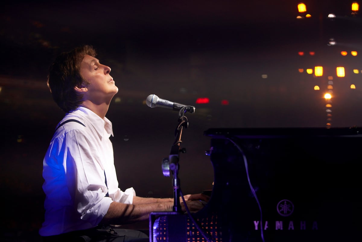 Paul McCartney plays the piano with his eyes closed