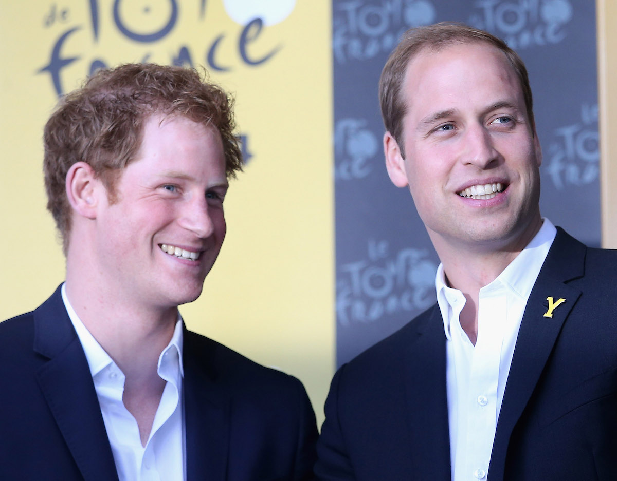 Prince Harry and Prince William, who have released their annual Christmas cards, smile together at an event.