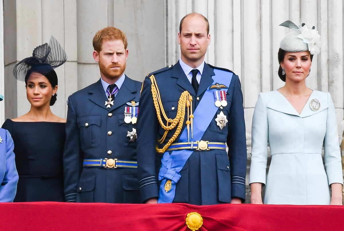 Meghan Markle, Prince Harry, Prince William, and Kate Middleton stand together at an event.