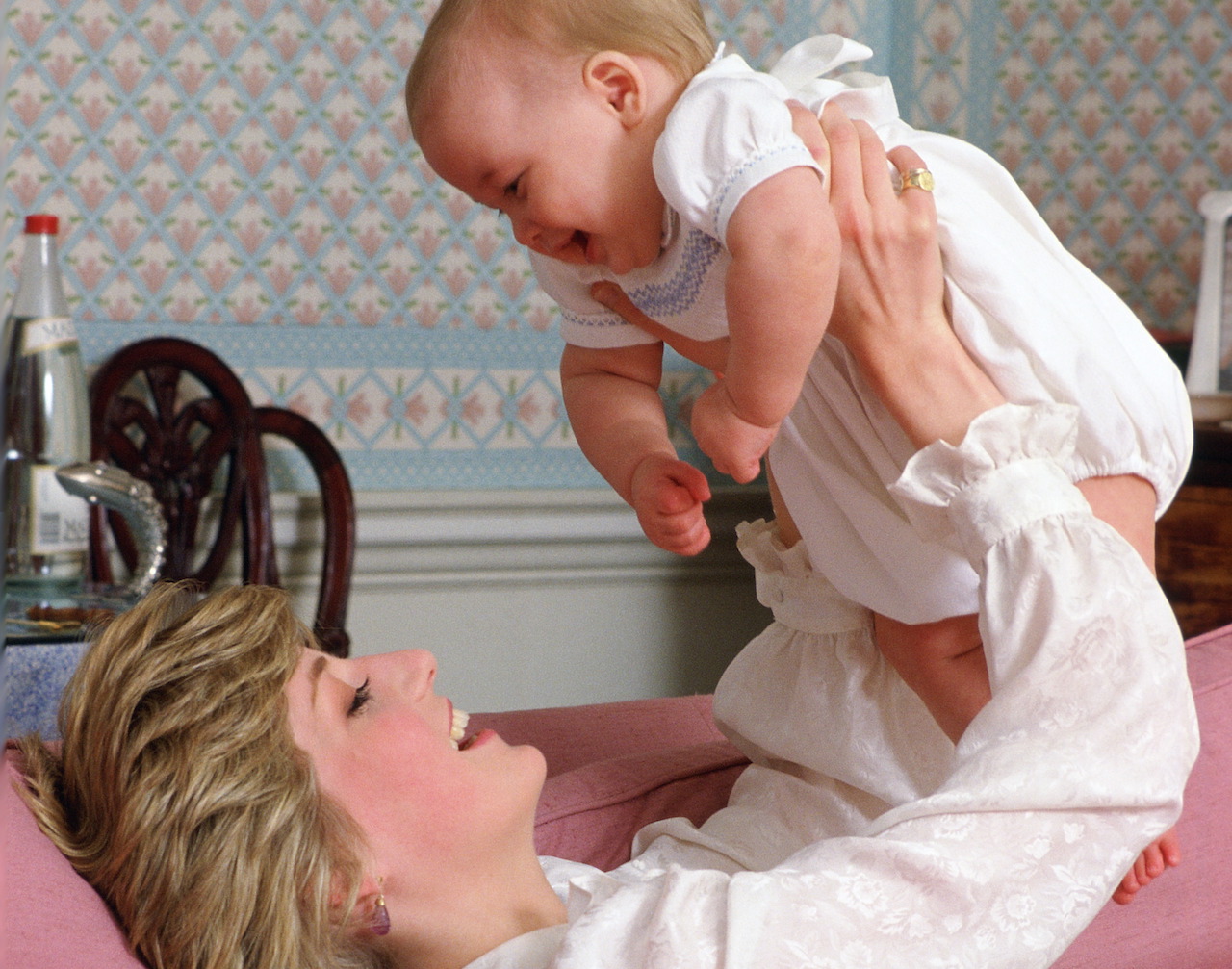 Princess Diana holding her baby son, Prince William, at home in Kensington Palace in 1983.