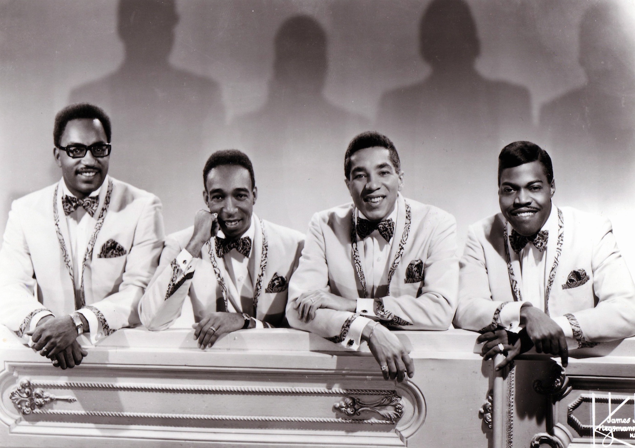 Smokey Robinson and the Miracles in white suits in 1965.