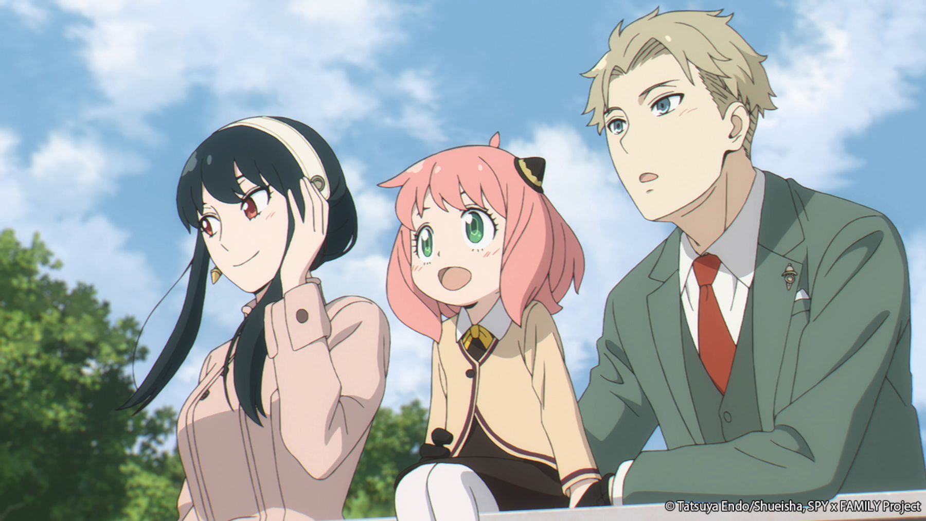 Yor, Anya, and Loid Forger in 'Spy x Family' for our article about episode 24 and its release schedule and preview. The Forger family is leaning on a railining and looking happily out at something. The sky behind them is blue.