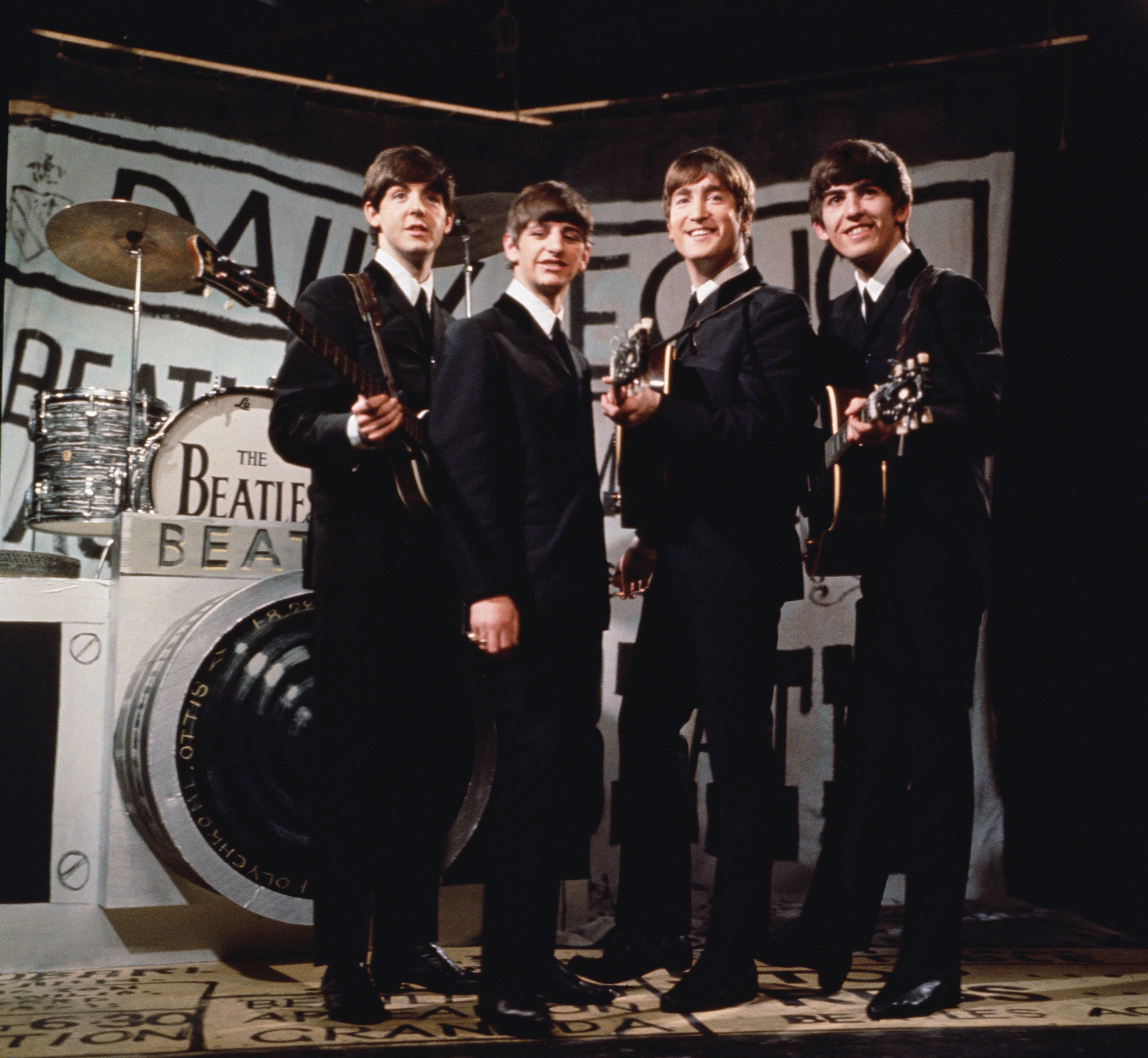 The Beatles, from left to right Paul McCartney, Ringo Starr, John Lennon (1940 - 1980), and George Harrison (1943 - 2001), performing in front of a camera-shaped drum kit on Granada TV's Late Scene Extra television show